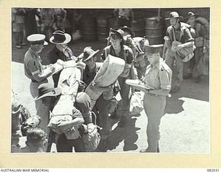 CAIRNS, QLD. 1944-10-30. TROOPS OF BRIGADE HEADQUARTERS 2/4 INFANTRY BATTALION BOARD THE USS MEXICO DURING MOVEMENT OF ELEMENTS OF 6 DIVISION TO NEW GUINEA. IDENTIFIED PERSONNEL ARE:- PRIVATE ..