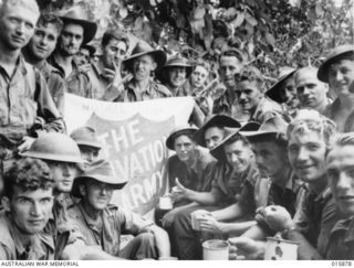 NEW GUINEA. ADVANCE ON LAE. 1943-10-01. AUSTRALIANS STOP FOR A HOT DRINK AT A SALVATION ARMY POST, NEAR THE BUREP RIVER. LEFT TO RIGHT, BACK ROW; WAYNE OSHEA, E. WORMLEATON, UNKNOWN, UNKNOWN, ..