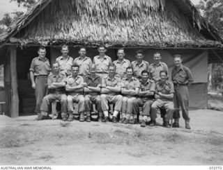 PORT MORESBY, NEW GUINEA. 1944-05-01. REGISTRY PERSONNEL, DEPUTY DIRECTOR OF ORDNANCE STORES, GROUPED OUTSIDE THEIR OFFICE IN THE CAMP STAFF AREA, HEADQUARTERS NEW GUINEA FORCE. IDENTIFIED ..