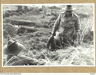 YOGE RIVER AREA, RAMU VALLEY, NEW GUINEA. 1943-12-18. VX1 GENERAL SIR THOMAS BLAMEY GBE KCB CMG DSO ED, COMMANDER-IN-CHIEF, ALLIED LAND FORCES SOUTH WEST PACIFIC AREA, CLIMBING A STEEP RIDGE DURING ..