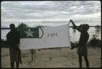 Men holding up a Christian Fellowship Church flag