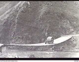 WAU-LABU, NEW GUINEA, 1945-12-13. BLAKES BRIDGE, A NEW SUSPENSION BRIDGE BUILT BY MEMBERS OF 8 MECHANICAL EQUIPMENT COMPANY OVER THE SNAKE RIVER