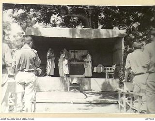 MADANG, NEW GUINEA. 1944-10-29. VX133080 CHAPLAIN J.J. RYAN, 2/11TH AUSTRALIAN GENERAL HOSPITAL, SUB DEACON READING PORTION OF THE SOLEMN HIGH MASS CELEBRATED ON THE LOCAL SPORTS GROUND. ALSO ..