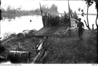 JABA RIVER AREA, BOUGAINVILLE, SOLOMON ISLANDS. 1944-12-18. 15 INFANTRY BATTALION SUPPORT TROOPS EMBARKING BY BARGE FOR TRANSPORT TO D COMPANY'S NEW POSITION ON THE SOUTH BANK OF THE JABA RIVER. ..