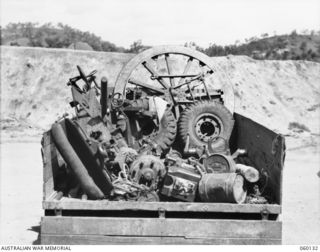 WARD'S DROME, NEW GUINEA. 1943-11-16. PARTS OF A DISMANTLED LONG; 25-POUNDER GUN WHICH TROOPS OF THE 2/5TH AUSTRALIAN FIELD REGIMENT, 7TH AUSTRALIAN DIVISION ARE TO PRACTICE LOAD INTO A DOUGLAS ..