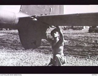 LAE, NEW GUINEA. 1943-10-11. STAFF SERGEANT DONALD FAIR, 376TH UNITED STATES SERVICE SQUADRON, 63RD SERVICE GROUP, WORKING ON A DAMAGED TAILPLANE OF A LOCKHEED LIGHTNING AIRCRAFT