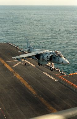 An AV-8B Harrier aircraft of Marine Heavy Helicopter Squadron 362 (HMH-362) takes off from the flight deck of the amphibious assault ship USS SAIPAN (LHA-2) as the vessel is underway in support of maritime interdiction operations