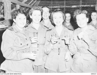 LAE, NEW GUINEA. 1945-03-26. AUSTRALIAN ARMY NURSING SERVICE PERSONNEL AT THE SISTERS MESS, 2/7 GENERAL HOSPITAL, DURING THE VISIT OF LADY WAKEHURST AND LADY BLAMEY. IDENTIFIED PERSONNEL ARE:- ..