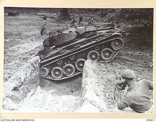 TOROKINA AREA, BOUGAINVILLE, 1945-08-08. AN M24 GENERAL CHAFFEE LIGHT TANK FAILING TO NEGOTIATE A DITCH EIGHT FEET WIDE, DURING TRIALS CONDUCTED FOR THE WAR OFFICE