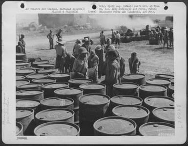 Japanese Soliders And Civilian Prisoners Of War Rolling And Stacking Gasoline Drums At A Supply Dump On Saipan, Marianas Islands. 29 June 1944. (U.S. Air Force Number 63576AC)