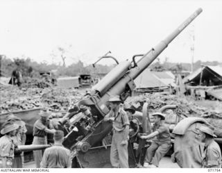 LAE, NEW GUINEA, 1944-03-26. MEMBERS OF C TROOP, 2/6TH HEAVY ANTI-AIRCRAFT REGIMENT (COMPOSITE), OPERATING "MAHFEESH-TOJO". (FINISH TOJO); NO. 3, 3.7 INCH MOBILE GUN, MKIII DURING AN ALERT. LEFT TO ..