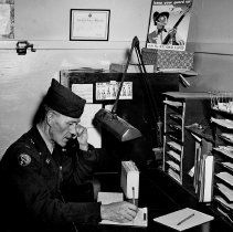 National Guard, Co. F Warrant Officer Ray Dielman at his desk in SW corner of Armory