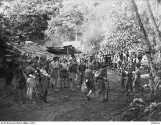 BOUGAINVILLE, 1945-06-06. TWO COMMANDO RAIDING PARTIES PREPARING TO MOVE OFF WITH NATIVE SCOUTS FROM NAIRONA VILLAGE, OUTLYING TROOP BASE FROM MOROKAIMORO, HELD BY B TROOP, 2/8 COMMANDO SQUADRON ..