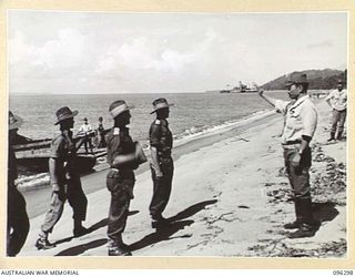 KAHILI, SOUTH BOUGAINVILLE. 1945-09-09. JAPANESE REPRESENTATIVE SALUTING MAJOR F.C. TAYLOR, BUIN LIAISON GROUP, 2 CORPS, ON THE BEACH AT KAHILI