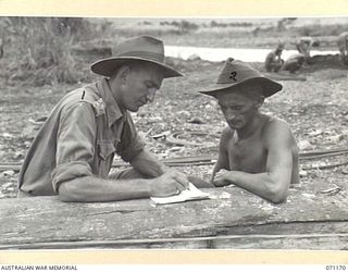 EVAPIA RIVER, NEW GUINEA, 1944-03-15. NX14685 LIEUTENANT A. YATES (1), OFFICER- IN- CHARGE NO.1 PLATOON, 2/4TH FIELD COMPANY, ROYAL AUSTRALIAN ENGINEERS, WITH NX14697 SERGEANT R. BURGOYNE (2), ..