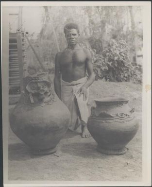 Man with two large sago pots brought to Awar plantation trade store, Awar, Sepik River, New Guinea, 1935 / Sarah Chinnery