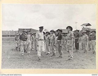 LAE AREA, NEW GUINEA. 1945-08-13. COLONEL I.J. WOOD, COMMANDING OFFICER, 2/7 GENERAL HOSPITAL, INSPECTING C COMPANY OF THE HOSPITAL STAFF