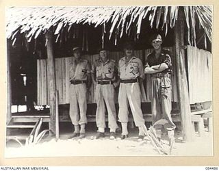 LABU, NEW GUINEA. 1944-12-18. 43 LANDING CRAFT COY OFFICERS, OUTSIDE THE COMMANDING OFFICER'S OFFICE. IDENTIFIED PERSONNEL ARE:- CAPTAIN C C MACNAUGHT, (1); MAJOR G D MITCHELL, COMMANDING OFFICER, ..