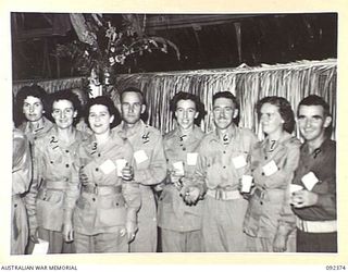 LAE, NEW GUINEA, 1945-05-23. AUSTRALIAN WOMEN'S ARMY SERVICE PERSONNEL AND INVITED GUESTS ATTENDING NUMBER 3 SERGEANTS' MESS, HEADQUARTERS FIRST ARMY. IDENTIFIED PERSONNEL ARE:- SERGEANT E.M. ..