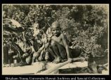 Boy sitting by taro