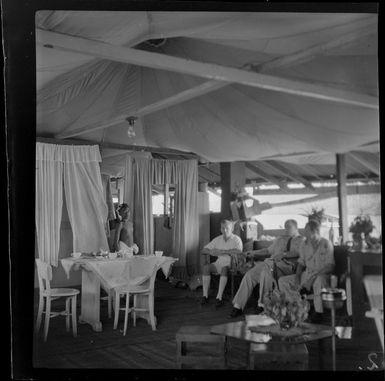 Group of unidentified people sitting at Mr Tyrell's house, Madang, Papua New Guinea