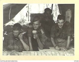 MELKONG RIVER, NEW BRITAIN. 1945-02-20. PERSONNEL OF THE 2/14TH FIELD REGIMENT, WORKING IN THE UNIT COMMAND POST DURING THE BOMBARDMENT OF THE JAPANESE POSITIONS IN THE WAITAVELO PLANTATION. ..