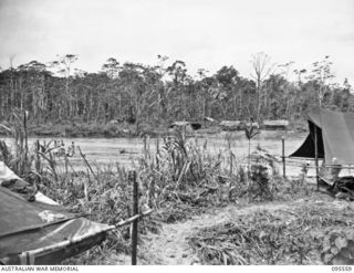 MIVO RIVER, BOUGAINVILLE, 1945-08-29. A GENERAL VIEW OF THE JAPANESE CAMP ON THE EAST BANK OF THE RIVER COMMANDED BY MAJOR FUJIE. THE AUSTRALIAN CAMP IN THE FOREGROUND ON THE WEST BANK IS COMMANDED ..