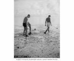 Scientists and researchers preparing to spear fish off of Namu Island, 1947