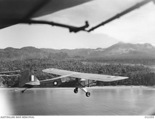 TOROKINA, BOUGAINVILLE ISLAND, SOLOMON ISLANDS. 1945-02-18. AN AUSTER AIRCRAFT OF NO. 17 AIR OBSERVATION POST FLIGHT RAAF PREPARING TO SPOT FOR ARTILLERY OVER BOUGAINVILLE ISLAND