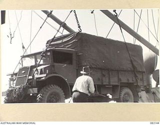 TOWNSVILLE, QLD. 1944-10-18. FIRST ARMY TRANSPORT VEHICLES BEING LOADED ABOARD THE LIBERTY SHIP SS JAMES OLIVER DURING EMBARKATION TO LAE, NEW GUINEA