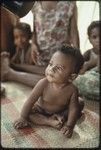 Infant on woven mat