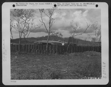 Revetment at an airdrome near Port Moresby, Papua, New Guinea, made from steel drums, used as protection for the plane against bomb explosions. (U.S. Air Force Number 77828AC)