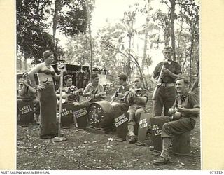 GUSIKA, NEW GUINEA, 1944-03-17. "TRENKNER'S TROUBADOUR BAND", FORMED BY MEMBERS OF THE 29/46TH INFANTRY BATTALION, 4TH INFANTRY BRIGADE, USING INSTRUMENTS CONTRIVED FROM .303 CARTRIDGES, BISCUIT ..