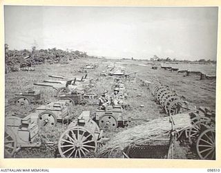 NAMATANAI, NEW IRELAND. 1945-10-29. ROWS OF JAPANESE GUNS, TANKS AND AMMUNITION TO BE DISPOSED OF. TROOPS OF 11 INFANTRY BATTALION, 13 INFANTRY BRIGADE, ARE SUPERVISING THE DUMPING OF ALL ARMS AND ..