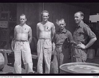 LAE, NEW GUINEA. 1945-12. POWER HOUSE PERSONNEL FROM 4 ADVANCED ORDNANCE DEPOT. LEFT TO RIGHT: N296916 PRIVATE (PTE) F. W. PENNINGTON; Q114849 PTE G. W. ZAHMEL; PTE GANE; V246358 PTE W. D. JONES