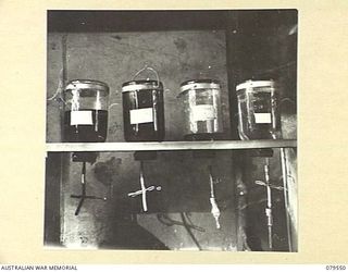 ORO BAY, NEW GUINEA. 1943-07. LOTIONS IN RACKS IN THE OPERATING THEATRE OF THE 10TH FIELD AMBULANCE