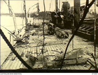 MILNE BAY, NEW GUINEA. 1944-04-05. THE BOAT DECK OF THE MOTOR VESSEL "ANSHUN" REFLOATED AT MILNE BAY HARBOUR BY THE COMMONWEALTH SALVAGE MARINE SERVICE INDICATING THE DAMAGE CAUSED BY SHELLFIRE ..