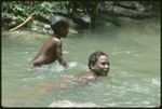 Girls swimming in the creek running by Uka'oi