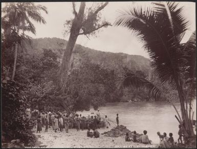 Missionaries and villagers gathered around a boat at the landing place of Suholo, Solomon Islands, 1906 / J.W. Beattie