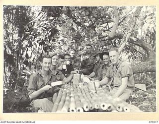 HANSA BAY AREA, NEW GUINEA. 1944-09-06. PERSONNEL OF C COMPANY, 25TH INFANTRY BATTALION ENJOYING THEIR MORNING TEA AT THEIR BAMBOO TABLE AT BOT BOT CAMP. IDENTIFIED PERSONNEL ARE:- CORPORAL L ..