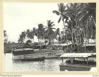 LABU POINT, LAE, NEW GUINEA. 1944-03-24. A GENERAL VIEW OF THE 1ST WATERCRAFT WORKSHOP SHOWING BUILDINGS, LANDING BARGES, SMALL CRAFT AND MACHINE SHOPS