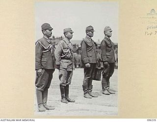 CAPE WOM, NEW GUINEA, 1945-09-13. A GROUP OF JAPANESE OFFICERS AT THE SURRENDER CEREMONY HELD AT CAPE WOM AIRSTRIP WHEN LT-GEN H. ADACHI, COMD 18 JAPANESE ARMY IN NEW GUINEA, FORMALLY SURRENDERED ..