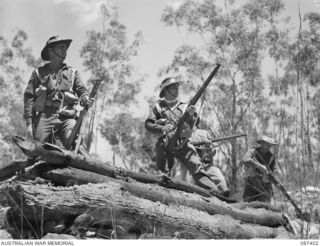 HERBERTON, QUEENSLAND. 1945-03-08. 2/48 INFANTRY BATTALION TROOPS FINISHING THE "MAD MILE" DURING THE GENERAL OFFICER COMMANDING 9 DIVISION GOLD MEDAL COMPETITION AT THE HERBERTON RIFLE RANGE