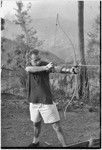 Unidentified white man practicing archery near Cooks' house in Kwiop