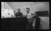 [Servicemen Elmer A. Ball and Chamberlin at bar in Quonset hut]