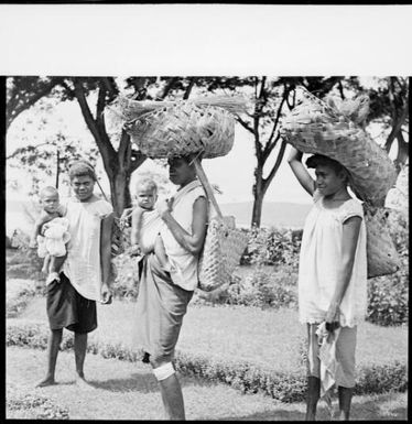 Three women, with two children, in Sarah Chinnery's garden, on way to Boong, the native market, Malaguna Road, Rabaul, New Guinea, ca. 1936 / Sarah Chinnery