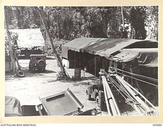 BOUGAINVILLE. 1945-08-30. GENERAL VIEW OF WORKSHOPS, 202 LIGHT AID DETACHMENT, ATTACHED HEADQUARTERS 3 DIVISION. THE GARAGE BREAK DOWN TRUCK IS IN POSITION AT END OF SHOP