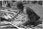 Splitting of bark to make the container to carry the finished taro and coconut pudding for presentation, and the making of the container