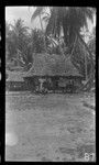 Man and children in front of house