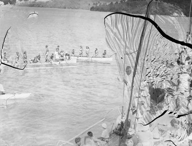 [Crowd on ship watch Pacific Islanders in canoes]